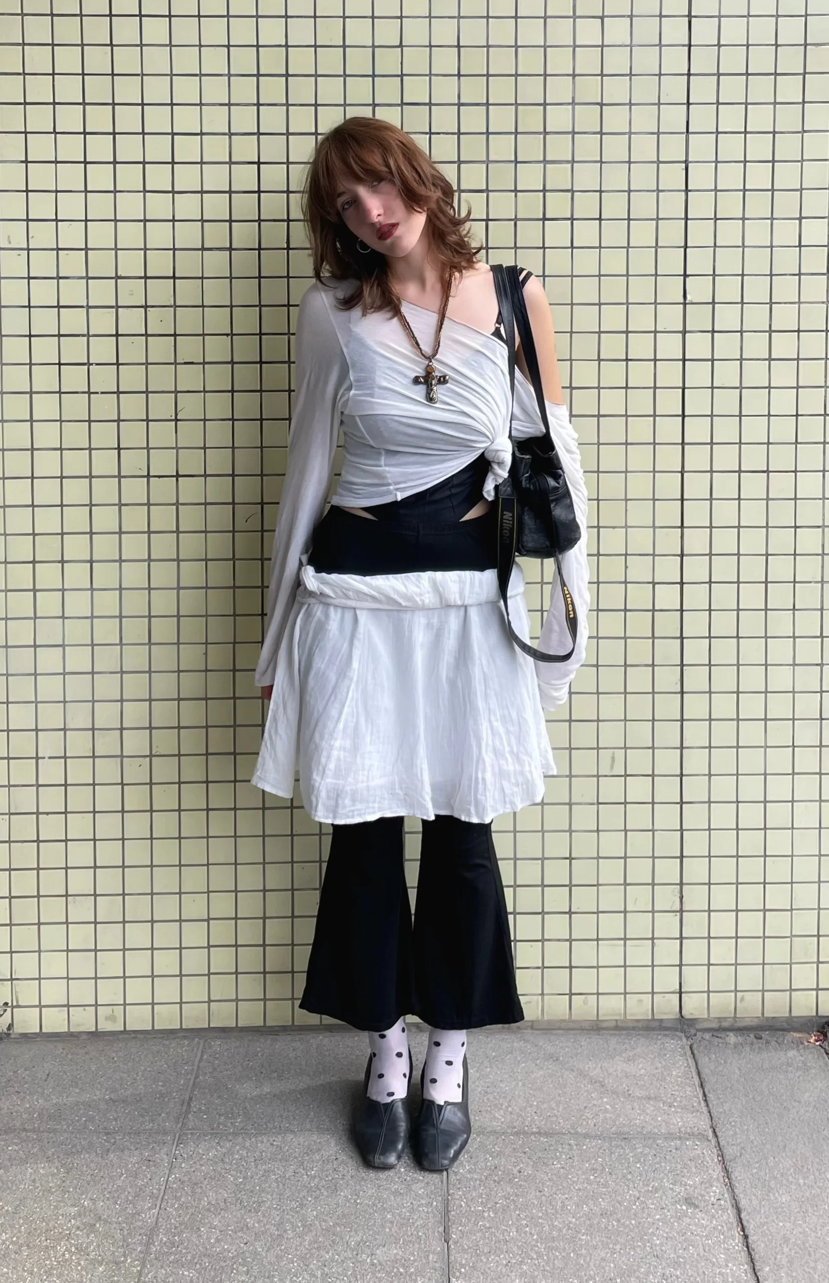 Photographer Anna Konoval by a tiled wall