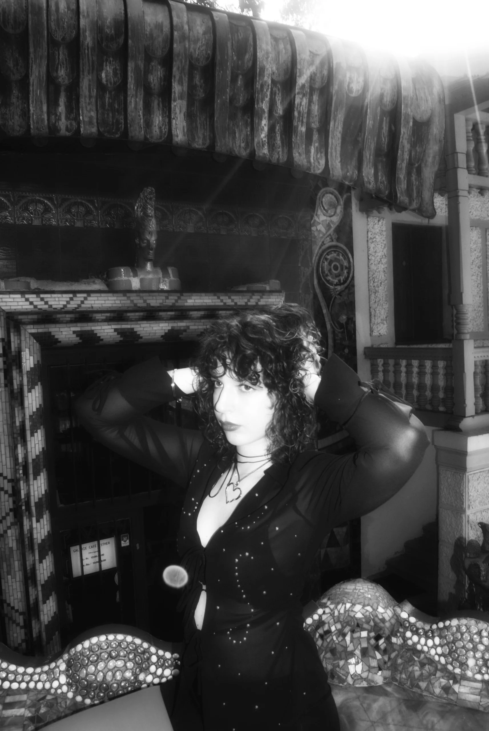 Black and white portrait in an embellished dress among the decor of the Otto Wagner Villa