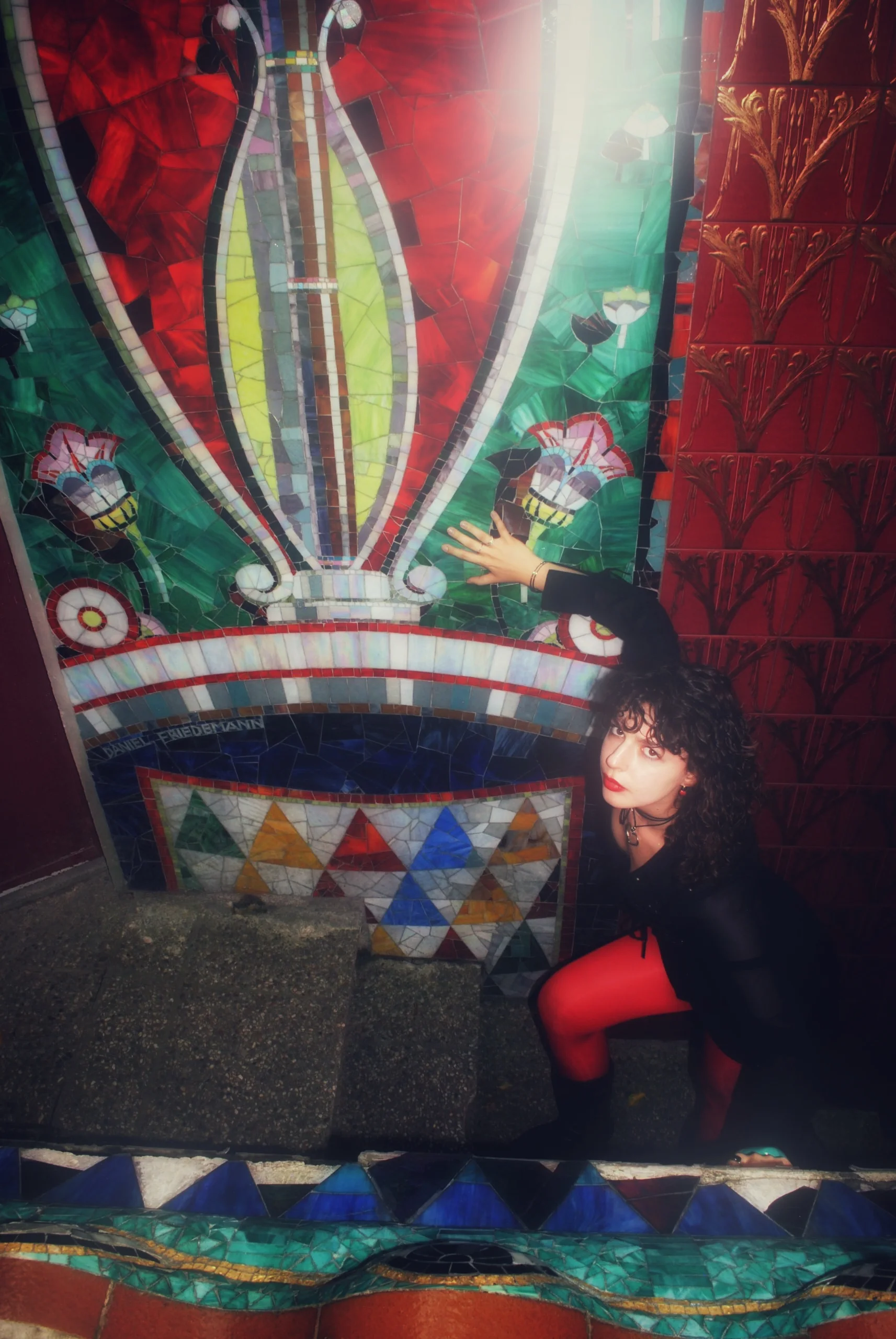 Red and green mosaic of the Otto Wagner Villa and a model in black with red tights